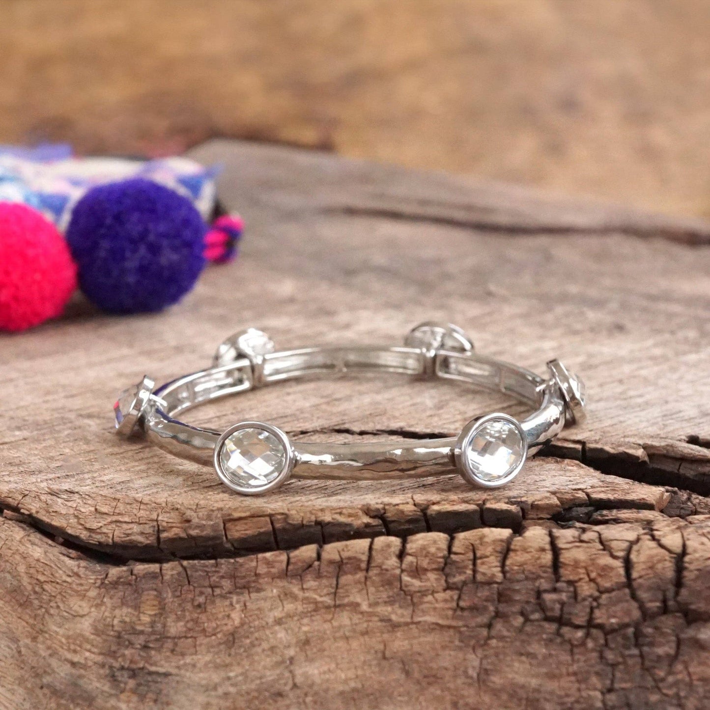 Jeweled Golden Bangle - with Faceted glass oval colorful jewels: Clear - Silver tone bangle