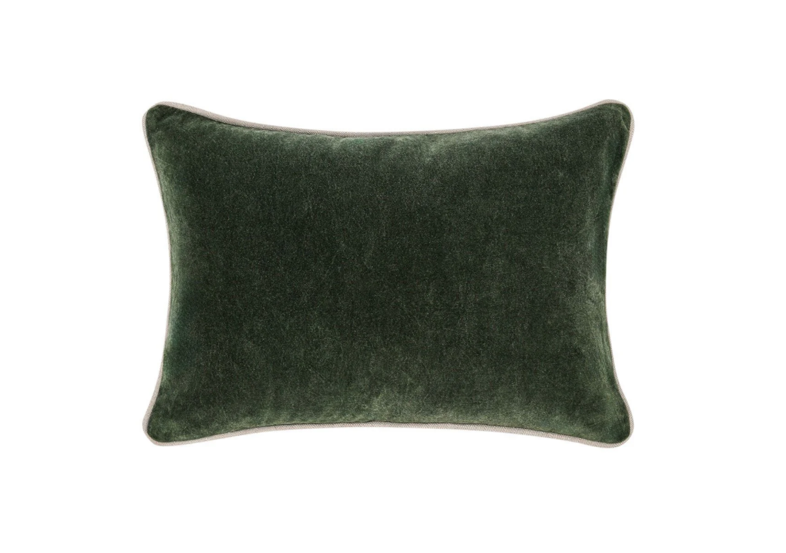 Green velvet pillow on a white background